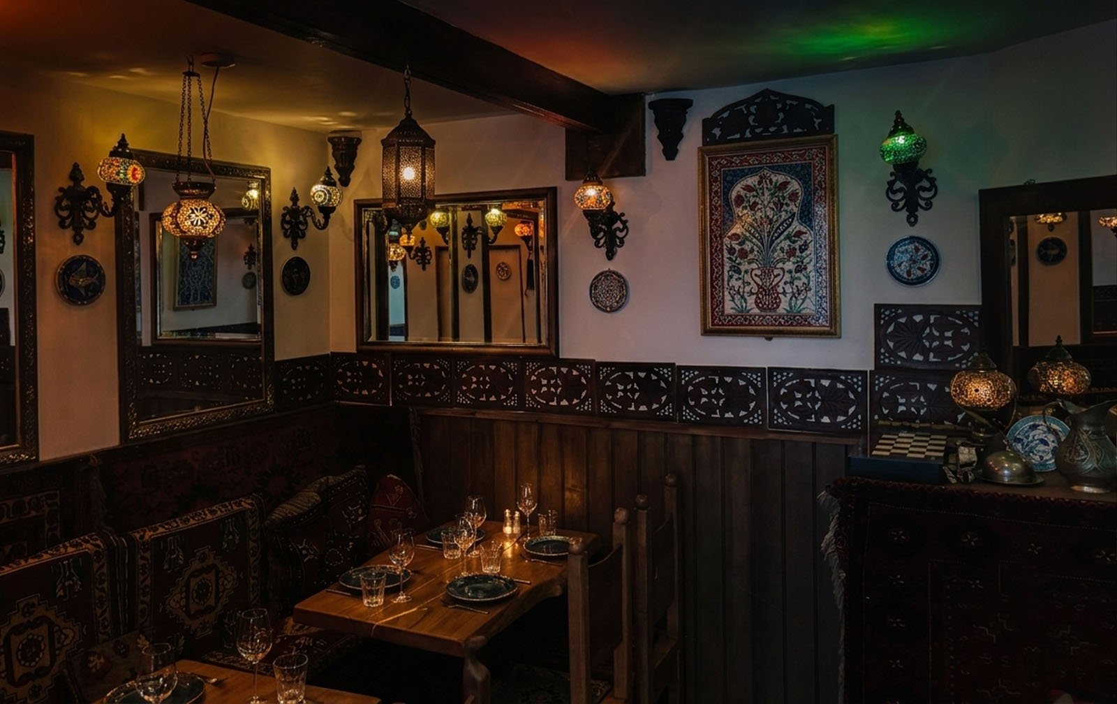 Empires Cafe Bistro interior with hand-painted çini tiles and brass lanterns